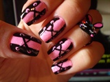 Pink corset nail art with a fun ring
