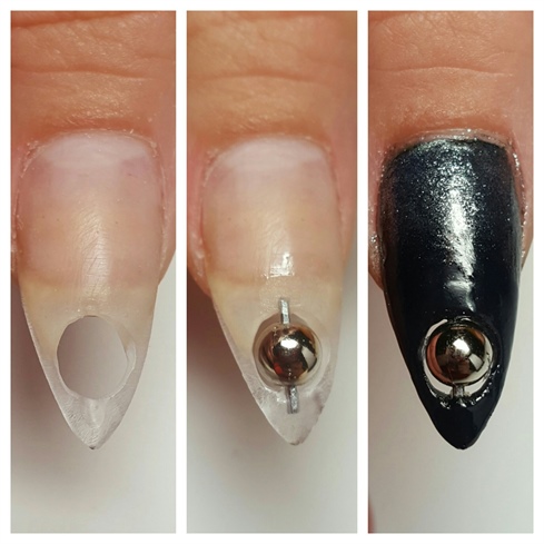 First I began by making the hole with different carbide and diamond efile bits.  Then I placed the bead on a small metal piece and encapsulated the ends with acrylic.  Then I polish with two coats of black polish and ombre'd the nail with a black metallic polish and a make up sponge. 