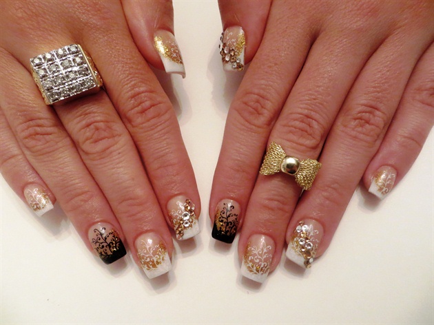 This modern day French is great for the day as it is classy and elegant with the white tips and the floral design. The random black accent nails add a trendy element to the design. When you’re ready for a night out you can dress them up with gold accessories. The crystals add just enough sparkle to catch your eye.  