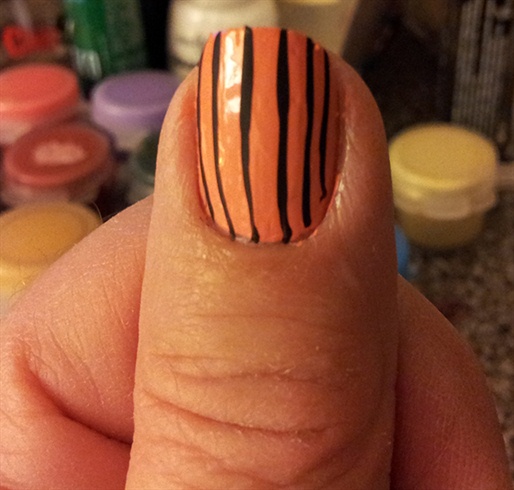 After your 2 coats of nail polish color is dry stripe your nails with either a striping polish or use a fine brush to make polish or acrylic stripes.