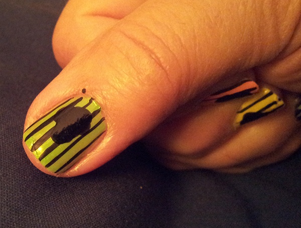 After your stripes are done, make a Head or Skull shape in the middle of your nail. Use your large dotter or paint brush.