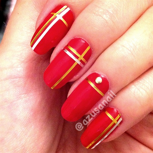red nails with gold tape