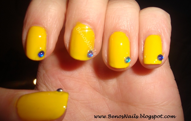 Yellow with blue stone