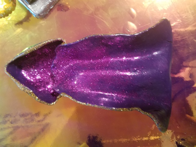 The cloak is hand painted with gel polish. I sprinkled purple glitter to back it pop in the background. its trimmed with gold gel polish and top coated with a tacky free top coat.