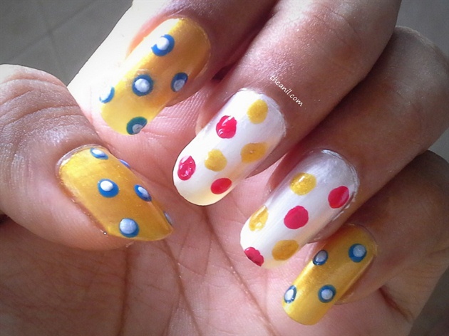 Make yellow and red dots randomly on white polish with matchstick.