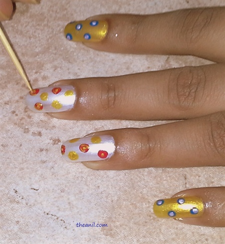 Using a toothpick place small dots,with red color on yellow and yellow on red dot, in the center and semi circle or “c” shape around the dot to look like rose petal.