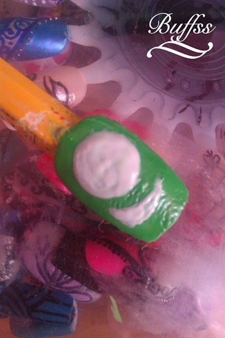 With white nail polish paint a big dot for his eye and paint the shape of his mouth.