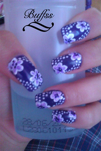 Purple nail art design with flowers
