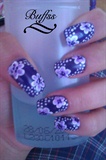 Purple nail art design with flowers