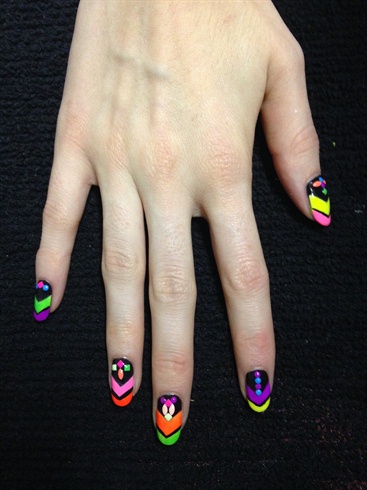 Add colourful studs in varying patterns in the black part of the nail. Top it off with a top coat and enjoy these nails under a blacklight!