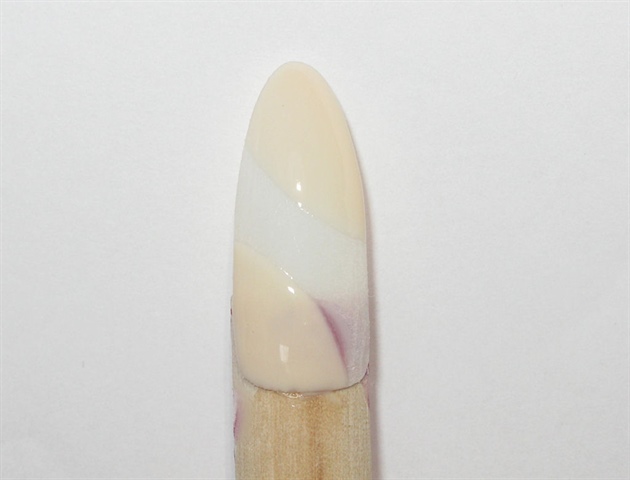 First step is to prep the natural nail for application of gel polish, or acrylic.  Use a buff/nude gel polish color to create the two curved spaces on the nail.  Cure and wipe off the tacky layer.