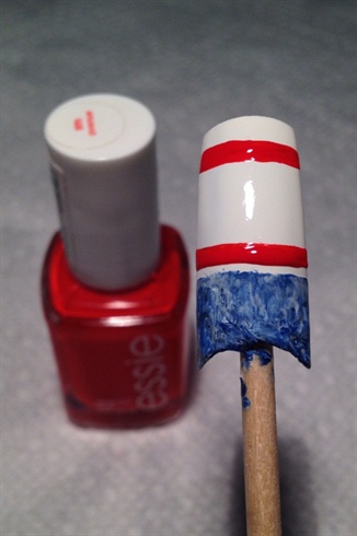 Apply two thick horizontal lines using your red polish.