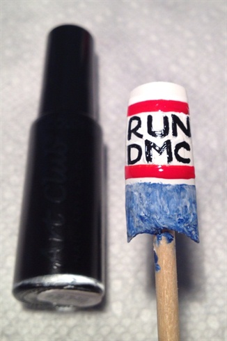 Using your black striper brush, paint on the 'RUN DMC