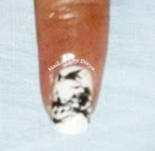 Remove tape and draw in between empty spaces using the nail art pen