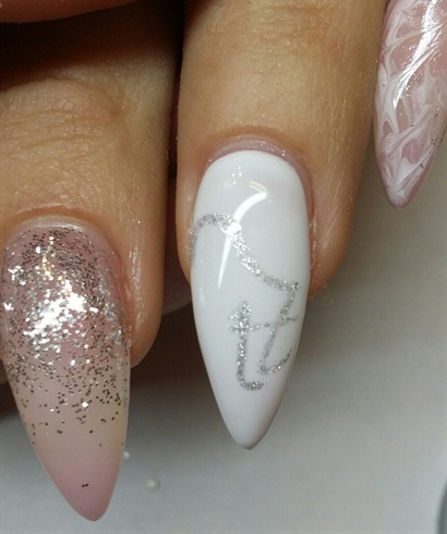 STEP 6:  On my all white nail, I used a silver gel to create the entity logo.  I used a small deatil brush to create the symbol and cures it fully.  I went back and added a second layer of a thin glitter gel over the symbol to give it some sparkle.  I then cured it again.