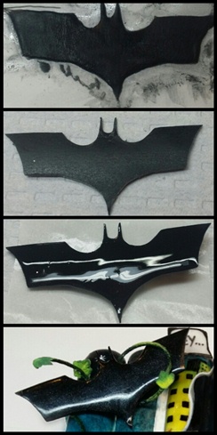 To create my Batman logo for my title page I used color acrylic.  I drew out the symbol on wax paper, and sculpted on top of it with acrylic.  When it dried I peeled it off the wax paper and used my efile to smooth and perfect it.  Next I top coated it with gel and patter on fine black glitter to give it some dimension.  I eventually wanted to logo to appear to be taken over by Poison Ivy's vines.