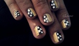 Polka dots on gold nails