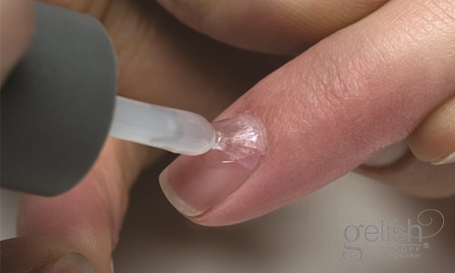Apply a thin coat of Gelish® Foundation from the cuticle to the free edge, capping free edge. Cure nails in an 18G LED light for 5 seconds or a UV light for 1 minute.