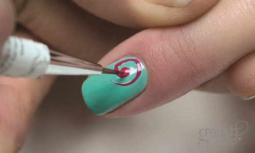 Use Harmony mini stripper gel brush with a small amount of Gelish® Soak-Off Gel Polish in “All Dahlia-Ed Up” to create a flower design on the nail. Cure nails in an 18G LED light for 30 seconds or a UV light for 2 minutes.  