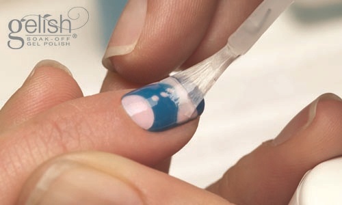 Apply a thin coat of Gelish® Top It Off Gel Sealer from the cuticle to the free edge to seal in the design on the nail (Remember to seal the edge of the nail). Cure the nails under the LED 18G light for 30 seconds or a UV light for 2 minutes. 