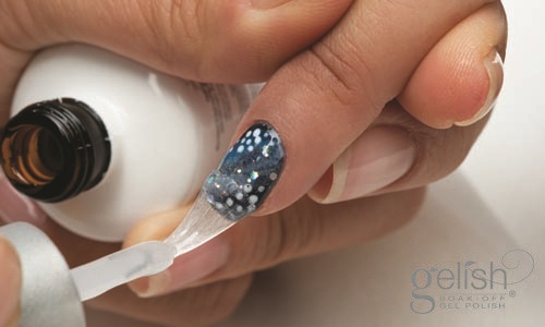 Apply a thin coat of Gelish® Top It Off Gel Sealer from the cuticle to the free edge to seal in the design on the nail (Remember to seal the edge of the nail). Cure the nails under the LED 18G light for 30 seconds or a UV light for 2 minutes. Remove the tacky residue on nails with the Gelish® Cleanser. Then, apply Gelish® Nourish Cuticle Oil to rehydrate moisture into the cuticle and the skin surrounding the nail.