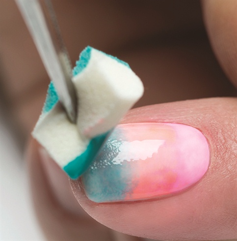 Using a makeup sponge, dab a small amount of the color Make You Blink Pink (Pink) near the cuticle area, I’m Brighter Than You (Coral) to the mid-section of the nail, and Radiance Is My Middle Name (Teal) to the edge of the nail. Blend the colors together with a Gel Striper brush. Cure nails under the LED 18G light for 30 seconds or a UV light for 2 minutes. Repeat step 6 one more time for an enhanced color effect.