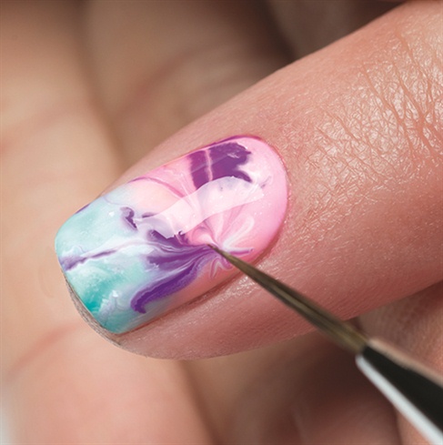 Wait for couple seconds until the colors open up, then use a Mini Striper brush to pull the colors toward one corner of the nail. Cure nails under the LED 18G light for 30 seconds or a UV light for 2 minutes.