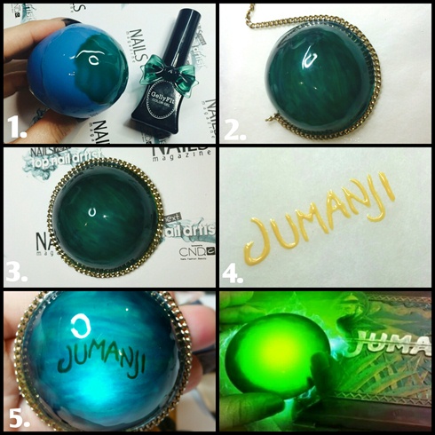 I half covered a small balloon with gel top coat, and layered blue and green sheer gel polish over the top.\nI painted Jumanji in yellow gel polish and gelled it to the underside. I added a small LED light underneath to illuminate the word Jumanji.