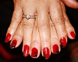 Red sparkly nails with black design