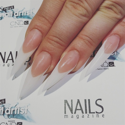 After capping the nails with clear acrylic, file and refine for smooth, seamless nails.