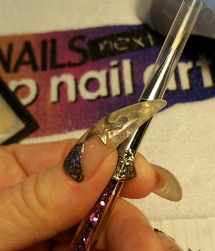 using an art brush I shaped my metal pieces to be curved to fit my nail.