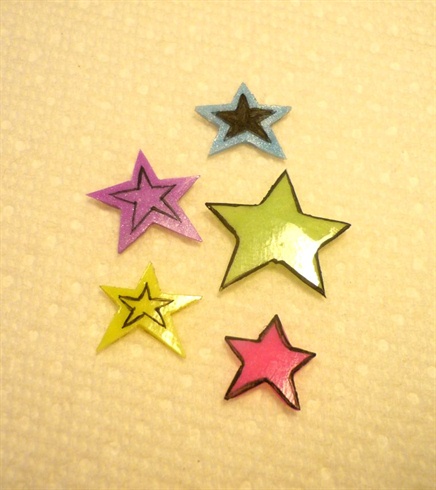 Once the acrylic was hardened I removed them from the form and used a pensil to outline the shapr of a star to guide me cutting out the shapes.  I used a carbide bit and cut out the stars and then used black acrylic paint to outline the stars or add a black outline of a star in the middle