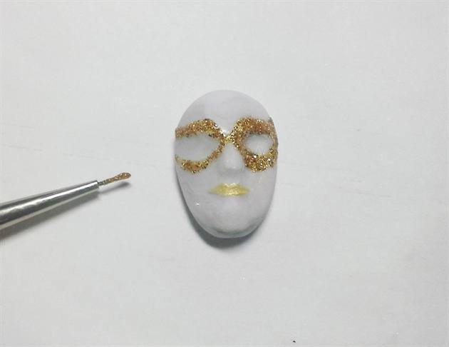 Decorate the face with gel, paint and embellishments.