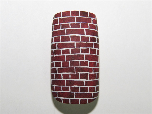 Then, paint a brick pattern with a slightly muted white paint and a thin striper brush