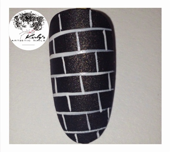 Use your nail art brush to draw a brick like pattern as seen in the photo.\n (If using a lighter background, use black to draw the pattern)\n