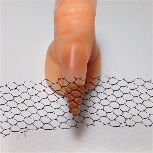 Using a piece of nail art netting, once the brown acrylic starts to lose its shine, gently press the netting into the acrylic to create texture. Remove any excess off the sides.