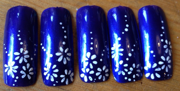 White flowers on dark blue nails