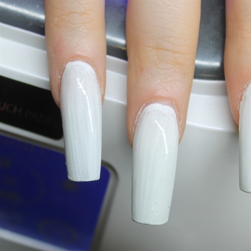 Add a layer of white gel polish on top of the nails before adding the colors, that way the green tone underneath wont show through the colors.