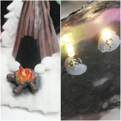 I dusted the snow with glitter to make it sparkle and added black pigment under the fire. I circled the hut's base with acrylic snow. I used tiny led lights attached to small batteries to light up the sky. I attached the lights with Blue-Tack so I can change the batteries when they run out.