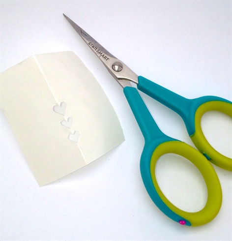 Use a piece of frisket (sold at the craft store in the airbrush section) to cut out a heart stencil.  