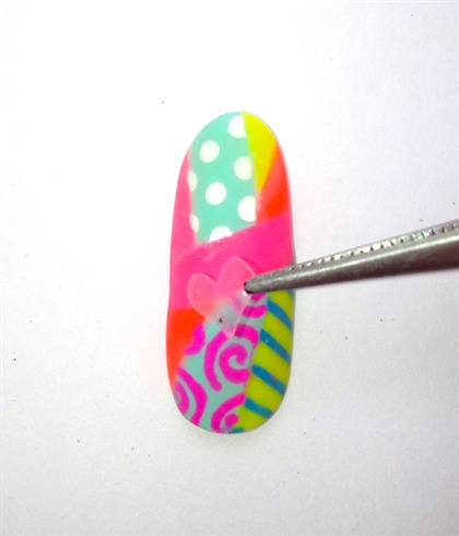Topcoat and swipe the nail with alcohol to protect the design.  Peel and stick the heart onto the clean dry nail.  