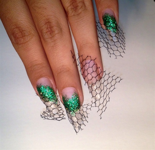 Next, I spread some emerald glitter over the nail bed and smile lines, and also attached some fishnet using nail glue.  