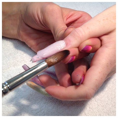 Encapsulate the nails with clear acrylic to preserve the glitter and color fade that was created.  Finish file.  