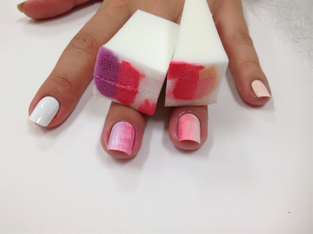 Use a makeup sponge to create a vertical ombre effect using candy colored polishes.  