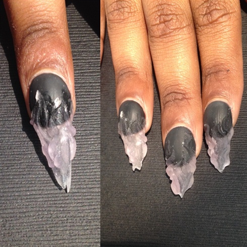 Apply a matte gel top coat to the black. Cure. Then start sculpting 3d flames using acrylic. Using the flames as a guide, shape the nails with an e-file.