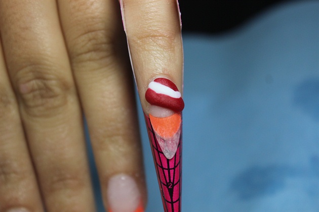 Using red and white acrylics begin sculpted the different layers of the pinkie. Use a very small bead and mold it into each swirl. Make sure to let each piece dry before you move onto the next. 