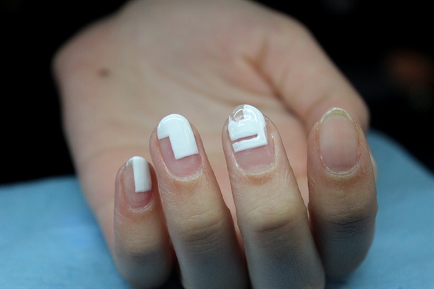 Continue to paint white shapes on the rest of the nails. Leave one empty for an accent nail later. 