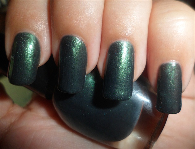 Apply base coat then paint your nails dark green