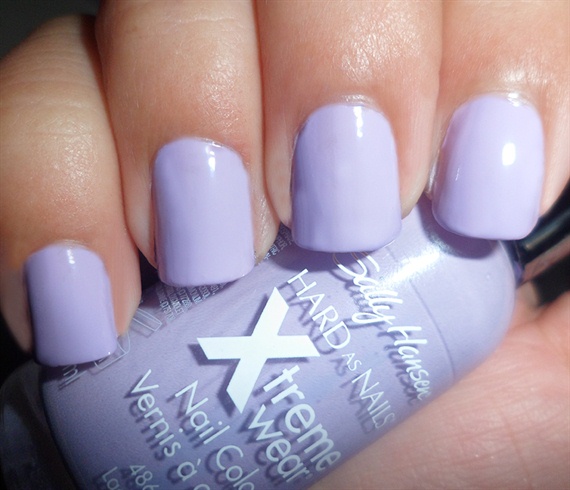 Apply Base coat to protect your natural nails then paint with a light purple nail polish.