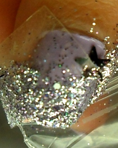 Dip your nail into nail glitter or sprinkle it.
